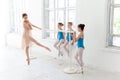 Three little ballerinas dancing with personal ballet teacher in dance studio Royalty Free Stock Photo