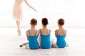 Three little ballerinas dancing with personal ballet teacher in dance studio Royalty Free Stock Photo