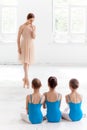 Three little ballerinas dancing with personal ballet teacher in dance studio Royalty Free Stock Photo