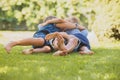 Playful siblings having fun on a green lawn