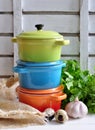Three little colorful cooking pots, eggs and garlic