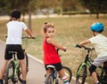 Three little cyclists riding their bikes and enjoy having fun. Kid outdoors sport summer activity Royalty Free Stock Photo