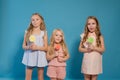 Three little girls girlfriend eaten sweet candy lollipop on a stick
