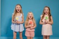 Three little girls girlfriend eaten sweet candy lollipop on a stick