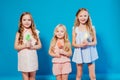 Three little girls girlfriend eaten sweet candy lollipop on a stick