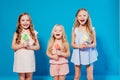 Three little girls girlfriend eaten sweet candy lollipop on a stick