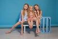 Three little girls girlfriend sit together portrait