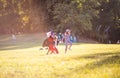 Three little girls in Halloween suits walking trough park and holding hands Royalty Free Stock Photo