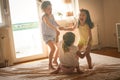 Three little girls having fun on bed. Royalty Free Stock Photo