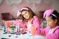 Three little girls having a party at home. Kids playing and drawing Royalty Free Stock Photo