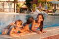 Three little girls playing in the pool Royalty Free Stock Photo