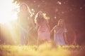 Three little girls playing together in nature. Holding hands and laughing Royalty Free Stock Photo