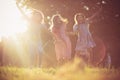 Three little girls playing together in nature. Holding hands and laughing Royalty Free Stock Photo