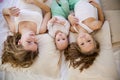 Three little girls sisters play in the bedroom on the bed Royalty Free Stock Photo