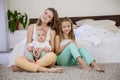 Three little girls sisters play in the bedroom on the bed Royalty Free Stock Photo