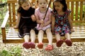Three little girls on swing Royalty Free Stock Photo