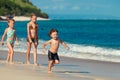 Three little kids playing at the beach Royalty Free Stock Photo