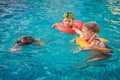 Three little kids playing in the swimming pool Royalty Free Stock Photo