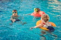 Three little kids playing in the swimming pool Royalty Free Stock Photo