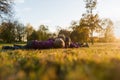 Three little kids, siblings, lying on an autumn grass