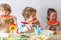 Three little kidseating healthy food watermelon Royalty Free Stock Photo