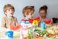 Three little kidseating healthy food watermelon Royalty Free Stock Photo