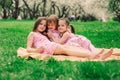 Three little sisters having a lot of fun playing together outdoor in summer park Royalty Free Stock Photo