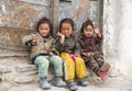 Three little Tibetan girls waving hands , Upper Mustang trekking, Nepal.