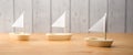 Three little wooden boats on wooden background - 3d illustration Royalty Free Stock Photo