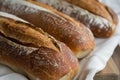 Three Loaves of Bread on Wooden Cutting Board Royalty Free Stock Photo