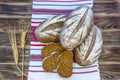 Three loaves of rye bread and pieces of sliced bread on a towel with Ukrainian national ornaments. Healthy food concept.