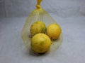 three local lemon in the mesh bag Royalty Free Stock Photo