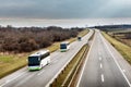 Three local line buses in line traveling on a highway