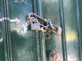 Three lock faces green painted door with rusted chain Royalty Free Stock Photo