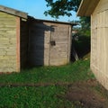 Three locked old wooden sheds