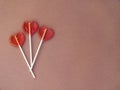 Three lollipops on brown background