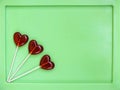 Three lollipops on green background Royalty Free Stock Photo