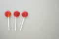 Three lollipops isolated on grey paper Royalty Free Stock Photo