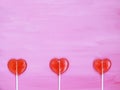 Three lollipops on pink background Royalty Free Stock Photo
