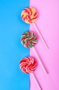 Three lollipops on pink and blue Royalty Free Stock Photo