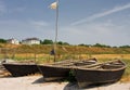 Three lone fishing boats on a sandy shoreline scenery