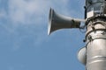 Three loudspeakers on pole against blue sky Royalty Free Stock Photo