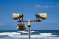 Three loudspeakers on a sea coast. Megaphone Attention. Royalty Free Stock Photo