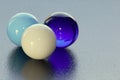 Three lovely coloured marbles on black surface - stock photo Royalty Free Stock Photo