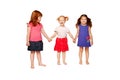 Three lovely smiling little girls holding hands