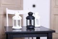Three luminaire two white and one black on black wooden table. S Royalty Free Stock Photo
