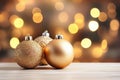 Three luxurious golden Christmas ornaments on a wooden table. Royalty Free Stock Photo