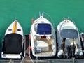 Three luxury boats in a marina