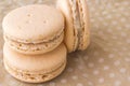 Three macaroni cake on a beige polka dot background. Top view