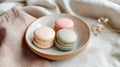 Three macarons in pastel colors are neatly placed on a ceramic plate, adding charm to the table Royalty Free Stock Photo